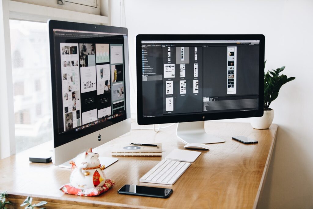 Web design workspace with dual monitors.